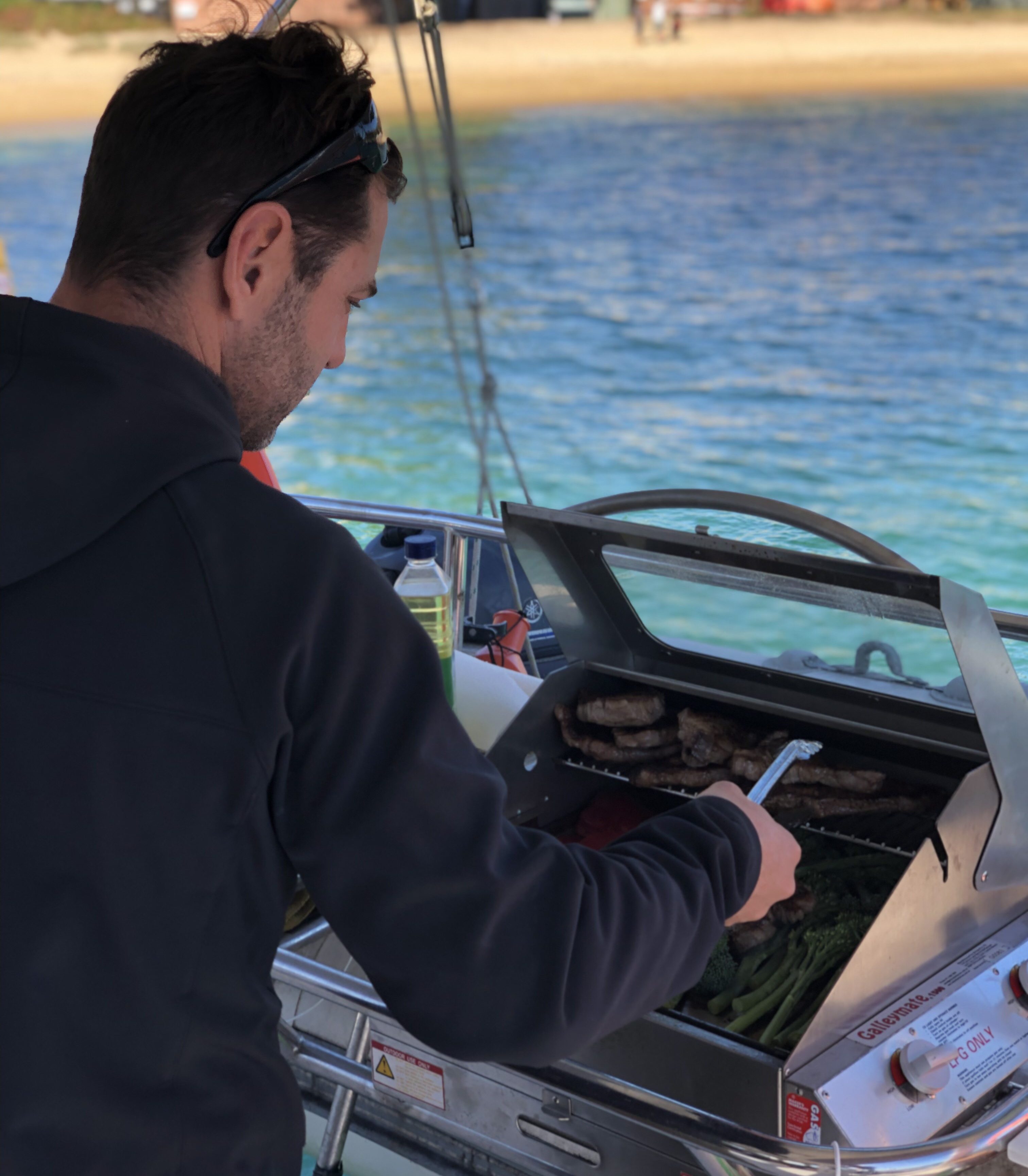 BBQ cooking onboard a Sydney Harbour catamaran charter