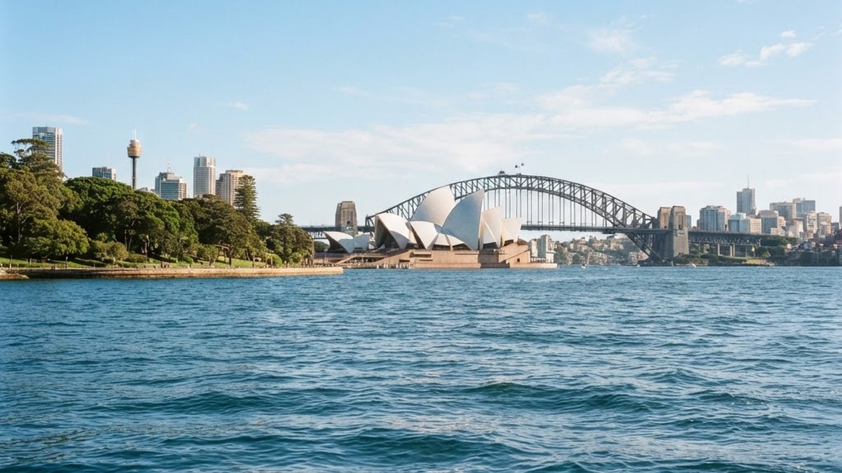 Sydney Opera House and Harbour Bridge skyline seen from the sparkling blue water of Sydney Harbour